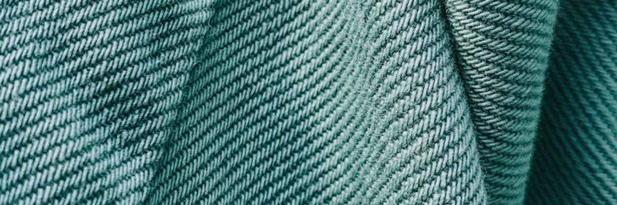 Minimalist composition of mint fabric and dark stone